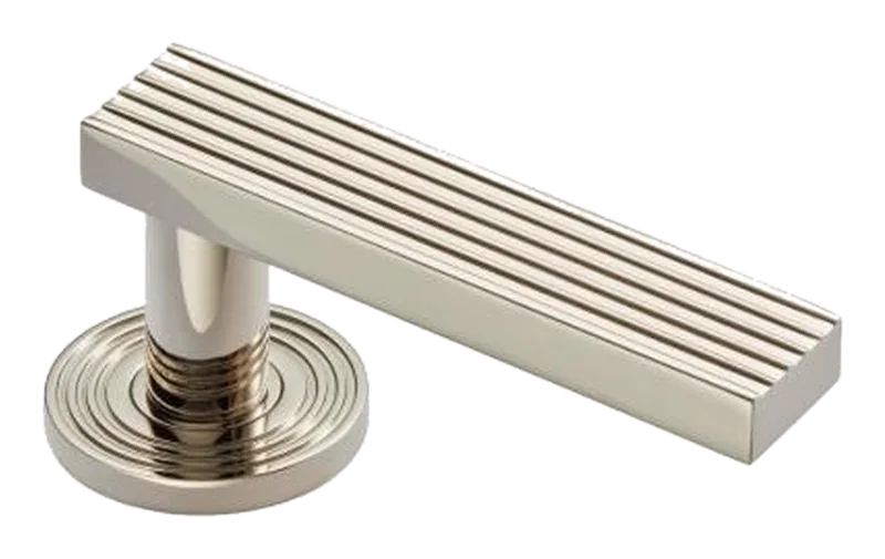 Fluted lever handle on a reeded round rose, polished nickel